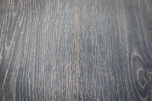 Dark brown wooden parquet floor texture as background.
