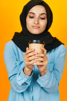 Muslim a glass of coffee a warming drink yellow background. High quality photo