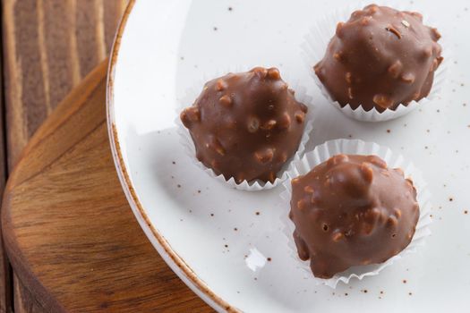 Small chocolate sweets with nuts close up. Dessert