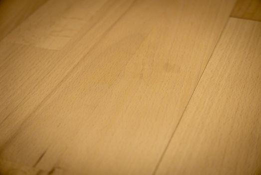 Yellow or light brown parquet texture as a background.