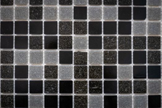 Gray ceramic mosaic on the wall as background.
