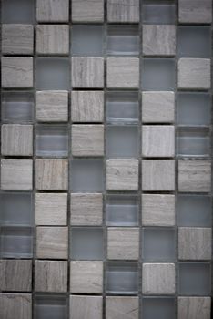Gray ceramic mosaic on the wall as background.