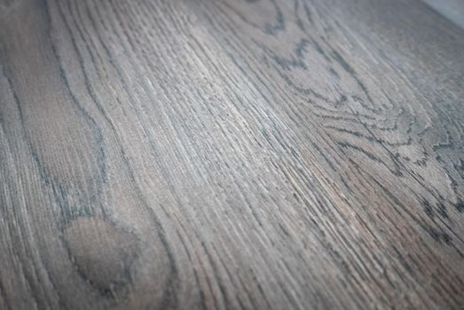 Dark brown wooden parquet floor texture as background.