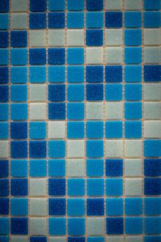 Blue ceramic mosaic on the wall as background.