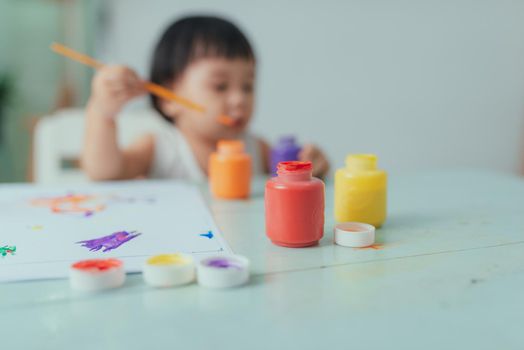 Healthy happy daughter experimenting with colors, water at home 