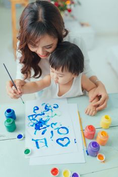 Asian mother working at home together with daughter