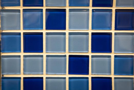 Blue ceramic mosaic on the wall as background.