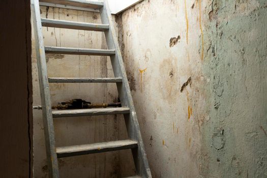 Cellar wooden Stairs leading down to stone and brick lower level in dark basement, old abandoned building scary