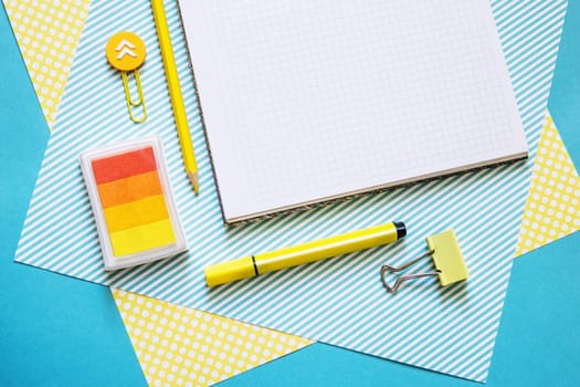School supplies. Yellow and blue colors. Empty notebook. Flat lay composition. Space for text. Back to school.