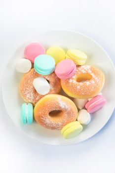 Different sweets isolated on white background, Doughnuts, macarons top view, unhealthy and candy concept copy space