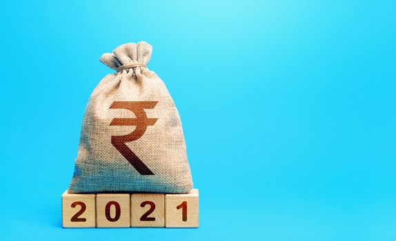 Indian rupee money bag and blocks 2021. Budget planning for next year. Revenues expenses, investment and financing. Beginning of new decade. Business plans and development prospects, trends