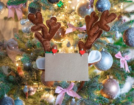 Christmas mail envelope with blank letter in decorated tree with reindeer ears for copy space close to, background, Holiday concept space for text