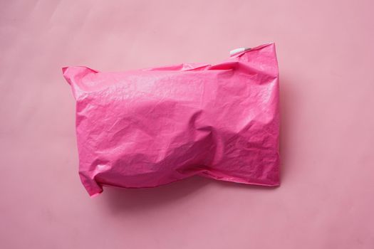 pink paper bubble envelope on table .