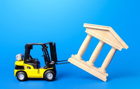 A forklift demolishes a bank building. Bankrupt bank liquidation procedure. Overthrow of government, dismantling of ruling elite. Financial system recovery. Elimination of the bureaucratized systems.