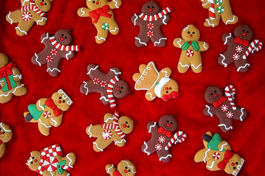 Christmas food. Gingerbread man cookies in Christmas setting. Xmas red background top view retro modern design various