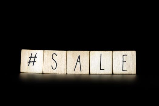 Hashtag and sale written on a black background with space for text. Concept of selling products online store, social media on Black advertisement