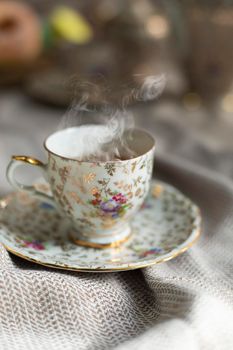 Porcelain tea pot and cup of hot tea on the table, antique traditional crockery set, high tea English afternoon tea cozy stylish interior