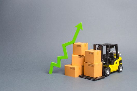 Yellow Forklift truck with cardboard boxes and a green arrow up. growth rate of production goods and products, raise economic indicators. Increasing consumer demand. exports and imports. sales rise