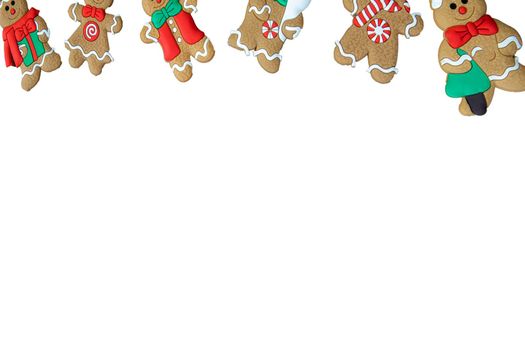 Gingerbread man cookies in a row isolated on white background, copy space, Christmas season,food and winter concept sweet