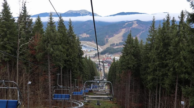 Ukraine, Bukovel - November 20, 2019. Autumn view of the ski resort with a chairlift against the background of autumn mountain slopes and the infrastructure under construction of a winter ski resort