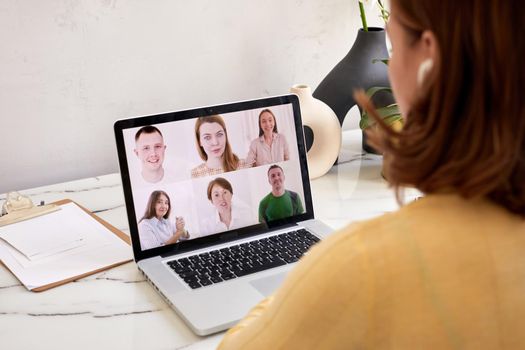Young woman talk on video call on laptop, millennial girl rest sit speak chat with colleagues, have webcam conference, technology concept