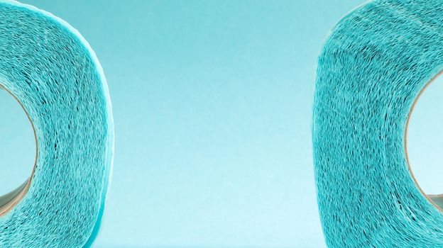 Blue roll of modern toilet paper on a blue background. A paper product on a cardboard sleeve, used for sanitary purposes from cellulose with cutouts for easy tearing. Embossed drawing. copy space