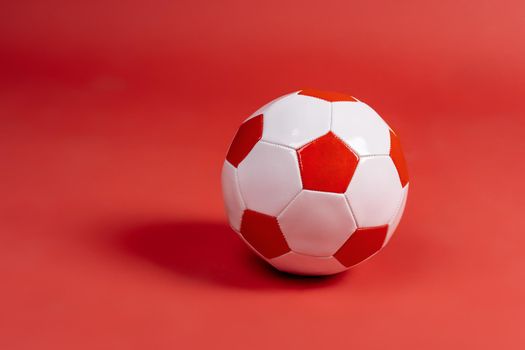 Ball for soccer game on a paper background. Close up.