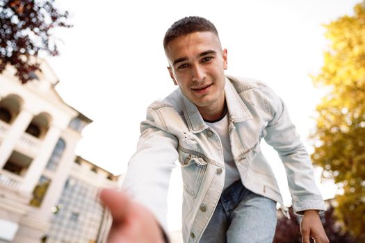 Portrait of young man taking a selfie while out on the city street, close up selfie