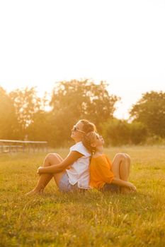 Two teenage girls have fun in the park. Two friends outdoor. Summwer people in glasses