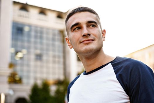 Portrait of handsome young casual man walking on the city street