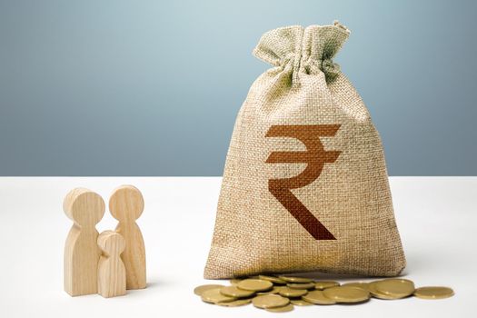 Indian rupee money bag with money and family figurines. Financial support for social institutions. Providing assistance to citizens. Investments in human capital, culture and social projects.