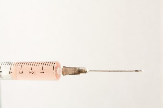 Medical syringe on a light background