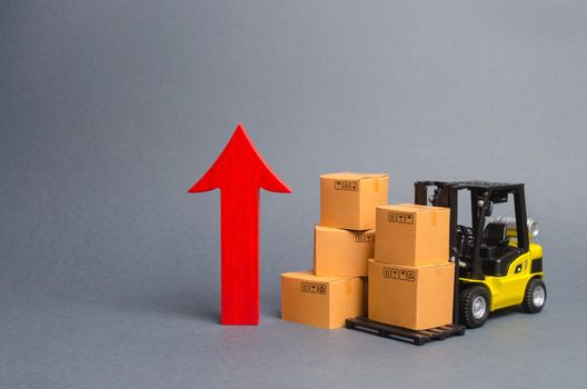 Yellow Forklift truck with cardboard boxes and a big red arrow up. increase in trade between countries, popularity of national goods, economic growth. growth rate of production goods and products,