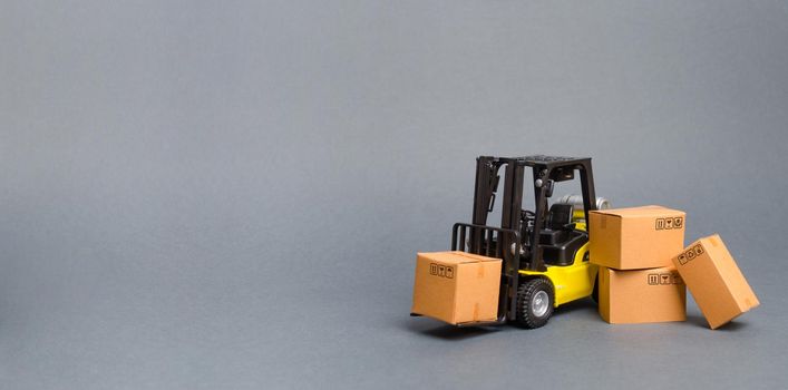 Yellow Forklift truck with cardboard boxes. Increase sales, production of goods. transportation, storage of cargo and goods. Freight shipping, delivery of goods. Logistics. retail. Banner, copy space