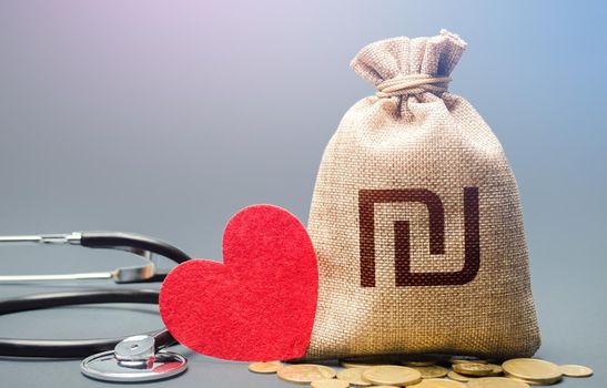 Israeli shekel money bag and stethoscope. Health life insurance financing concept. Funding healthcare system. Reforming and preparing for new challenges. Subsidies. Development, modernization.
