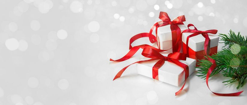 Christmas Gift's in White Box with Red Ribbon on Light Background. New Year Holiday Composition Banner. Copy Space For Your Text