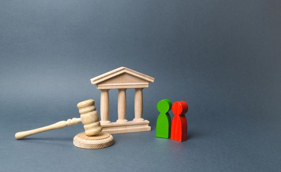 Two figures of people opponents stand near the courthouse and the judge's gavel. The judicial system. Conflict resolution in court, claimant and respondent. Court case, settling disputes.