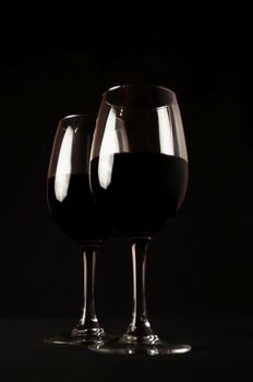 Red Wine. Two Glasses of Red Wine on Black Background