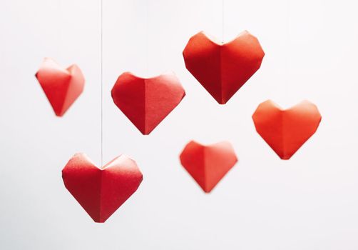 Many paper origami red hearts, symbol of love for greeting card in Valentines day.