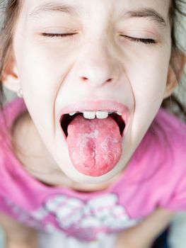 A child at the doctor. The doctor examines the throat of a child.