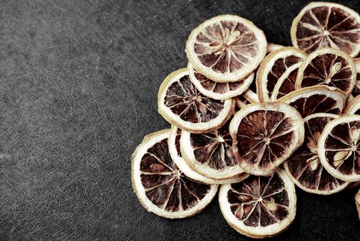 close up of dry lemon on a black background , top view