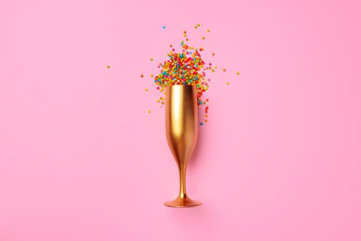 Champagne glass with confetti flat lay top view, christmas background