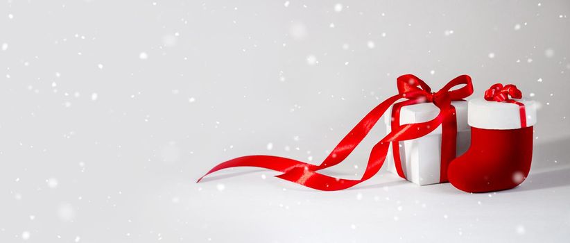 Christmas Gift's in White Box with Red Ribbon on Light Background. New Year Holiday Composition Banner. Copy Space For Your Text