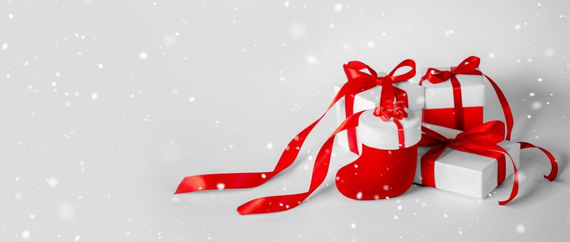 Christmas Gift's in White Box with Red Ribbon on Light Background. New Year Holiday Composition Banner. Copy Space For Your Text