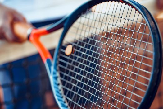 Tennis racket and tennis net on tennis court close up