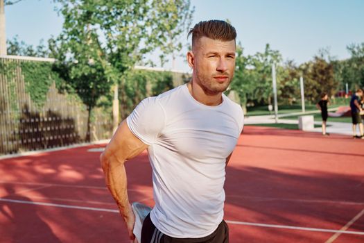 man doing exercises outdoors on the playground. High quality photo