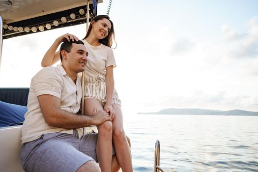 Loving couple spending time on a yacht at the open sea