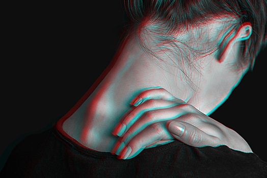 Anaglyph effect of woman touches her pain neck.