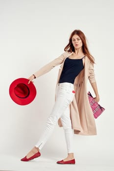 pretty woman wearing a red hat posing shopping fun studio model. High quality photo