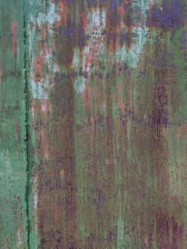 Corroded metal background. Rusted painted metal wall. Rusty metal background with streaks of rust. Rust stains. The metal surface rusted spots. Rystycorrosion.